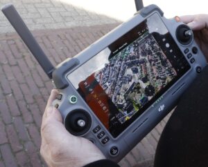 Op scherm van afstandsbediening drone een schoolomgeving